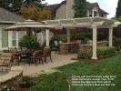 Kitchen with Red Kennesaw Ledge Stone Walls and Granite Counter Tops. 3_16”  Salmon Bay Aggregate Patio with El  El Dorado Flagstone Band and Wall Cap