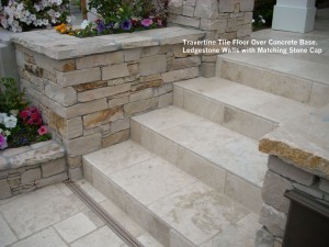 Travertine Tile Floor Over Concrete Base. Ledgestone Walls with Matching Stone Cap